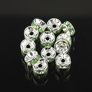 Distantiere argintii cu rhinestones verzi 7mm (3,2x7mm)